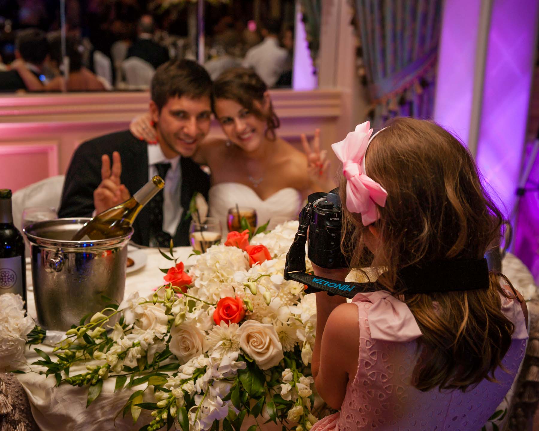 7 year old girl photographs the happy couple at a wedding with a full-frame DSLR Sony A900