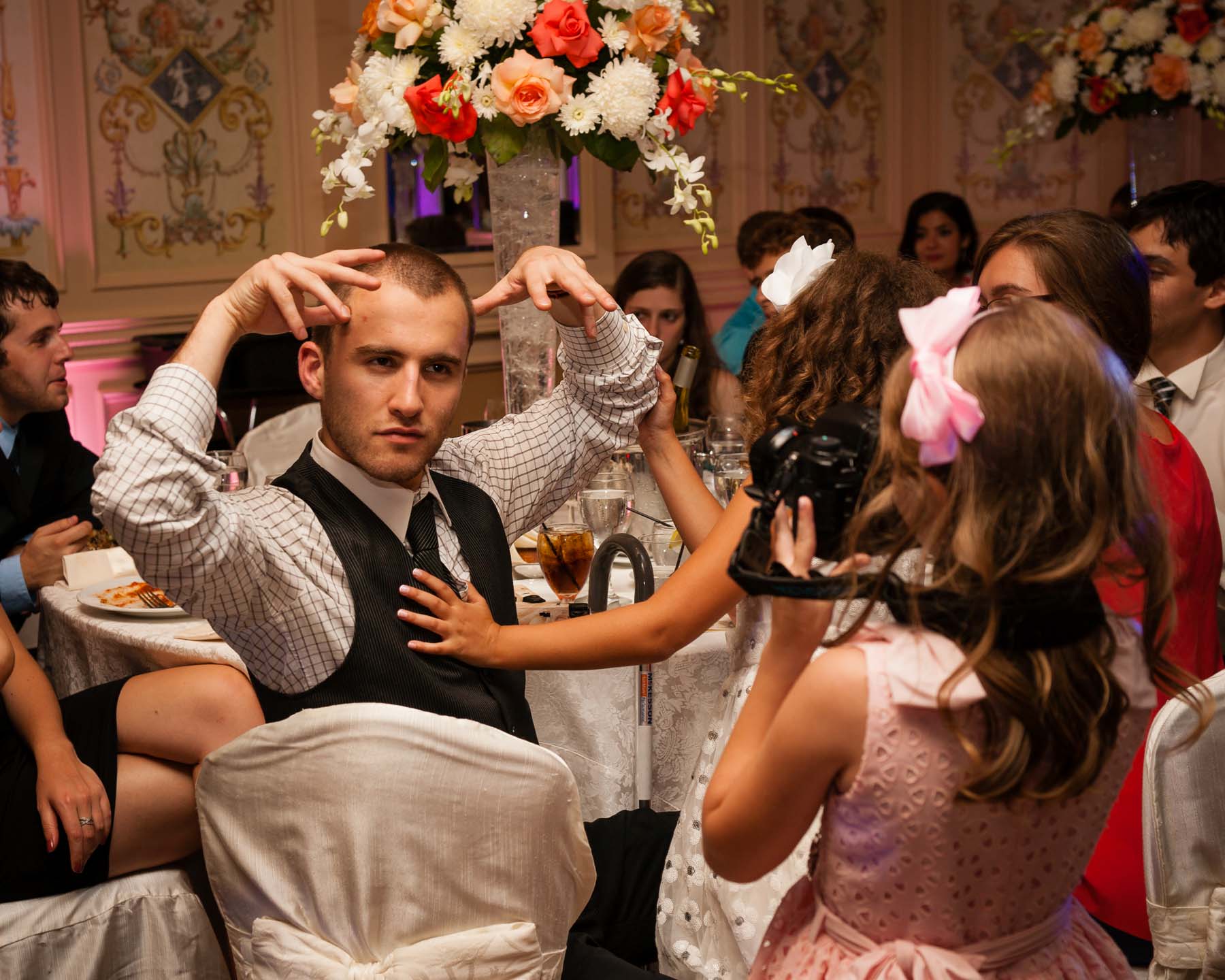 7 year old girl photographs a guest at a wedding with a full-frame DSLR Sony A900